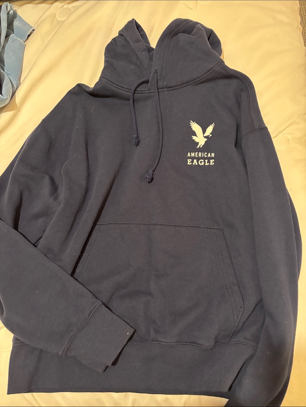 American Eagle Outfitters navy blue pullover hoodie with cream logo
